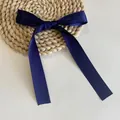 Elegant navy blue satin ribbon bow hair clip on a natural straw mat background - Duckbill Hair Clips / Short/PC / Navy Blue
