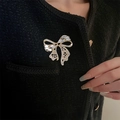 Elegant gold bow brooch with sparkling crystals pinned on a black tweed coat - Gold Rhinestone Bow (E31050)