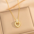 Detailed close-up of a heart-shaped gold pendant necklace with cubic zirconia on a jewelry box - Gold Necklace (8895)