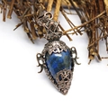 Detail of vintage copper lapis lazuli bottle pendant with star and heart engravings - Lapis Lazuli