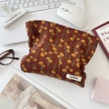 Detailed texture of brown corduroy makeup bag with small yellow floral patterns - Brown Daisy