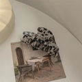 Macro shot of large faux acetate claw clip with marbled pattern on vintage postcard - Dragon Bone Claw / Black and White Leopard Print