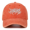 Detailed close-up of white gothic embroidery on an orange washed cotton baseball cap - Orange
