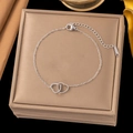 Silver interlocking hearts bracelet made of stainless steel in a premium beige jewelry box - Love Heart Pendant Bracelet (E2249) / Steel