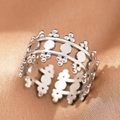 Macro shot of silver bohemian open ring with hollow design on brown silk fabric - Silver Crown Ball (C1476)