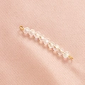 Detail of faceted rainbow crystal beads with gold wire connectors on pink fabric - 4# White