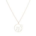 Detailed close-up of a gold-plated circular pendant with two cats and star silhouettes - Cat and Star / Gold