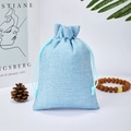 Light blue linen drawstring gift pouch with natural pine cone and wooden bead decor - Blue