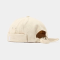 Detailed close-up of beige docker hat with N embroidery and adjustable metal buckle - Beige