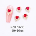 Macro view of 10mm red heart gem nail charms with gold Love engraving and white rhinestones - Hollow Love Border Nail Art Charm (9686)