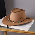 Brown felt cowboy hat with shell and turquoise decor resting on a vintage book - Khaki