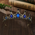 Macro shot of vintage gold tiara with blue oval gems and black crystals on wooden desk - Bronze Base Blue Zirconia