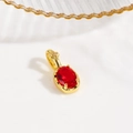 Detail showing an 18k gold plated turtle pendant with an oval red gemstone and floral bail - Red (Oval Style)