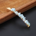 Close-up of natural light blue crystal stones wrapped on a gold-tone hair clip - Aquamarine Gold