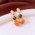 Detailed shot of irregular gold stud earrings with tiger eye bead and orange resin pendant - Silver Pin - Gold - Orange