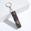 Detail of cylinder keychain with black rhinestones and colorful star patterns - C22-Black Star