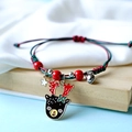Handmade woven Christmas bracelet with red and green cord and reindeer charm - Brown Deer