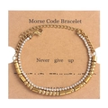 Close-up of golden Morse code double-layer bracelet with rhinestones on display card - Never Give Up Gold