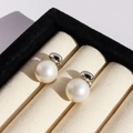 Elegant white pearl stud earrings with silver finish displayed in a jewelry gift box - White Gold