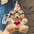 Brown plush bear keychain in white heart sweater with black goggles and strap - White Sweater Red Heart Bear