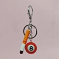 Mini cigarette and billiard ball keychain with silver metal rings on pink background - Short Cigarette with Red Pool Ball