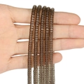 Detail of hand-held dark brown square spacer beads with polished translucent finish - 150 Pieces / Smoky Quartz