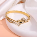 Gold-plated evil eye bangle with black pupil, white enamel, and sparkling crystals - Curved Pave Diamond Eye Bangle