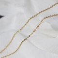Golden O-chain necklace made of copper with a smooth finish on white fabric - Basic Chain-Gold