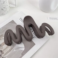 Large matte dark brown wave-shaped hair claw clip for thick hair displayed on desk - 13cm / Chocolate Brown