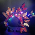 Detail of LED light-up headband with colorful faux butterflies and small battery box - Red Butterfly Headband With Multi-Color Lights