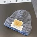 Cute gray knitted baby beanie featuring a plush brown bear patch and embroidered label - LUCK Bear Gray