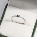 Detail of silver letter D ring with zircon accents in a green velvet jewelry box - Platinum D