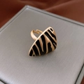 Detailed macro view of French vintage gold zebra pattern ring with matte finish texture - Gold Zebra Striped Triangle Style