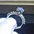 Macro detail of six-prong silver ring with twisted band and accent ruby on the base - US 7 / Rose Red