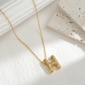 Minimalist gold letter H pendant necklace with a polished balloon-style 3D design - Letter H