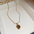 Macro detail of 18K gold plated necklace featuring an oval tiger eye stone in a jewelry box - Oval Gold Trim Brown Gem (27#)