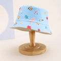 Close-up of sky blue kids bucket hat with colorful cartoon fruit patterns on wood stand - Kids One Size / Sky Blue (Cartoon Fruit)