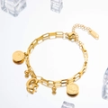 Gold stainless steel coin bracelet with letter G and layered chains on ice backgrounds - Letter G