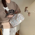Detail of quilted cosmetic bag with cute bear prints and floral patterns in hand - Flower Bear