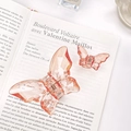 Amber pink butterfly hair claws in two sizes placed on a decorative French book - Large & Small Set / Pink