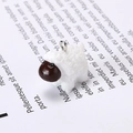 Close-up of a resin sheep charm with curly white texture and a silver metal hanging ring - Little Sheep