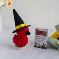 Handmade crochet red duck wearing a black wizard hat on a round wooden base with gift card - Devil Duck + Card + Hat + Base
