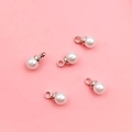 White round pearl pendants with silver metal caps for DIY jewelry making on pink background - 4mm Silver Round