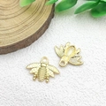 Golden bee-shaped metal charms for DIY jewelry making on white textured background - 1pc Insect Bee Charm