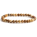 Macro detail of natural stone beaded bracelet showing earthy brown and grey textures - Jasper