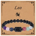Macro shot of Leo zodiac natural stone beaded bracelet with character description card - Leo