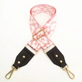 Detail of pink and white leopard print bag strap with brown leather and gold hardware - Pink