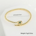 Gouden slangenarmband met groene edelstenen ogen en witte zirkonia-accenten - Stijl 3