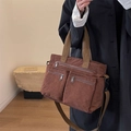 Brown corduroy shoulder bag with multiple zippers and textile straps shown by model - Brown