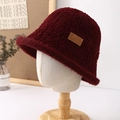 Detail of burgundy plush bucket hat showing faux fur texture and leather side label - Burgundy